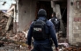 A State Police officer walks amid remains caused by a car bomb explosion outside the municipal police station in Ojocaliente, Zacatecas, Mexico, on August 31, 2026. Photo by JESS MIRELES / AFP