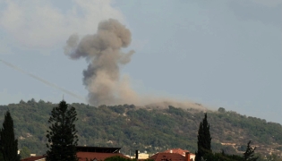 (FILES) A photograph taken from the southern Lebanese area of Nabatieh shows smoke as it rises from the site of Israeli strikes that targeted the hilltops of the mountainous area of the strategic Ali al-Taher Ridge on August 14, 2026. (Photo by AFP) /