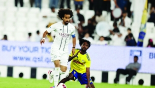 Al Sadd's Akram Afif (left) controls the ball.