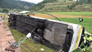 This handout photograph released on September 11, 2026 by the Swiss Police of Canton Graubunden shows the wreckage of a bus after an accident in between the village of Susch and Zernez, eastern Switzerland, on September 10, 2026. (Photo by Handout / KANTONPOLIZEI GRAUBUNDEN / AFP) 