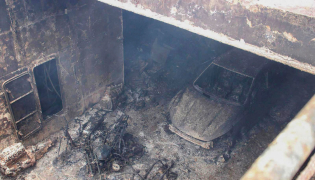 This handout photo taken on September 11, 2026 and released by the Philippine Coast Guard (PCG) shows a burnt vehicle and the burnt frames of motorbikes in the cargo hull of the M/V June Aster off the shores of Coron town, Palawan province. (Photo by Handout / Philippine Coast Guard (PCG) / AFP)