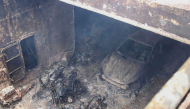This handout photo taken on September 11, 2026 and released by the Philippine Coast Guard (PCG) shows a burnt vehicle and the burnt frames of motorbikes in the cargo hull of the M/V June Aster off the shores of Coron town, Palawan province. (Photo by Handout / Philippine Coast Guard (PCG) / AFP)