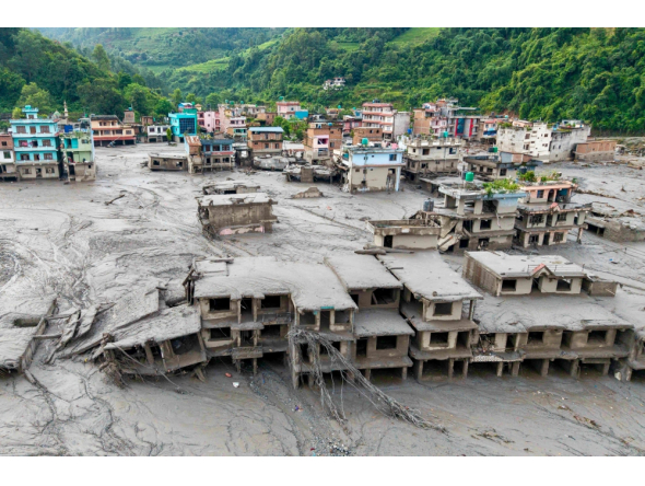 (Files) An aerial view shows houses lying deluged in sludge after flash floods at Devighat, Bidur Municipality in Nepal's Nuwakot district on August 27, 2026. (Photo by Prabin Ranabhat / AFP)