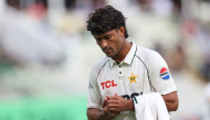 Pakistan's Razaullah leaves the field for treatment on an injury on day four of the third Test match between England and Pakistan at Edgbaston cricket ground in Birmingham on September 12, 2026. (Photo by Darren Staples / AFP) 