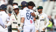 England's Joe Root (C) hugs Pakistan's Razaullah (2nd R) at the end of play on day four of the third Test match between England and Pakistan at Edgbaston cricket ground in Birmingham, central England, on September 12, 2026. (Photo by Darren Staples / AFP)