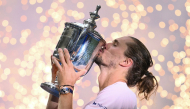 Germany's Alexander Zverev kisses the trophy after defeating USA's Ben Shelton in the men's singles final tennis match on day fifteen of the US Open tennis tournament at the USTA Billie Jean King National Tennis Center in New York on September 13, 2026. (Photo by ANGELA WEISS / AFP)