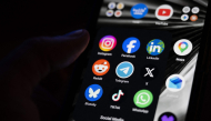This photograph shows a set up smart-phone screen displaying the logo of main social media platforms including Instagram, Facebook, LinkedIn, Reddit, Telegram, X, Bluesky, Tiktok and Whatsapp in Saint-Mande, east of Paris, on April 29, 2026. Photo by Martin LELIEVRE / AFP