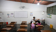 A teacher talks to her students during a class at the beginning of the school year in La Guaira, Venezuela on September 15, 2026.  (Photo by Federico PARRA / AFP)