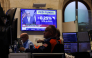 A television displays news of the US Federal Reserve's interest rate hike as traders work on the floor of the New York Stock Exchange (NYSE) in New York on September 16, 2026. (Photo by TIMOTHY A. CLARY / AFP)