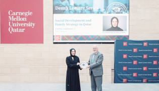 Minister of Social Development and Family H E Buthaina bint Ali Al-Jabr Al-Nuaimi receiving a memento from Dean of CMU-Q Michael Trick. 