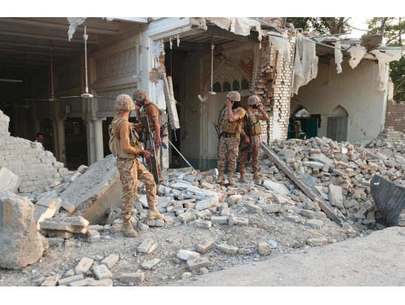 Army personnel stand amid the rubble following an explosion inside the police headquarters at Kohat in Pakistan's Khyber Pakhtunkhwa province on September 18, 2026. (Photo by Basit Shah / AFP)