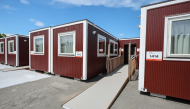 This picture taken on August 26, 2026 and released on September 18, 2026, shows temporary container huts being used to house athletes for the 2026 Asian Games at the Garden Pier in Nagoya. (Photo by JIJI Press / AFP) 