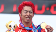 Japan's Takumi Hojo holds his gold medal on the podium of the men's individual triathlon during the 2026 Asian Games, on September 20, 2026. (Photo by JIJI Press / AFP) 