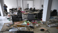 A journalist takes pictures of abandoned equipment at a closed cyber scam centre in Bavet town, Svay Reang province on September 21, 2026. (Photo by TANG CHHIN SOTHY / AFP)