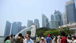 People gather at Marina bay waterfront in Merlion park in Singapore on September 29, 2026. (Photo by Roslan Rahman / AFP)