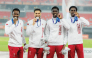 Qatar’s 4x400m relay quartet of Ammar Ibrahim, Bassem Hemeida, Youssef Djibrine and Ismail Abakar celebrate on the podium.
