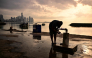 A fisherman washes at the fishing terminal in Panama City in the early hours of the morning on September 24, 2026. (Photo by Martin Bernetti / AFP)