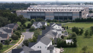 This aerial view shows an Amazon Web Services (AWS) data center adjacent to single-family homes in Stone Ridge, Virginia on August 12, 2026. Photo by Brendan Smialowski / AFP