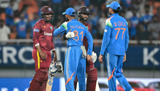 West Indies' captain Shai Hope (2R) and Gudakesh Motie (L) greet India's Ruturaj Gaikwad (2L) and captain Shubman Gill at the end of the third one-day international (ODI) cricket match between India and West Indies at the Maharaja Yadavindra Singh International Cricket Stadium on the outskirts of Chandigarh on October 3, 2026. (Photo by Sajjad HUSSAIN / AFP)