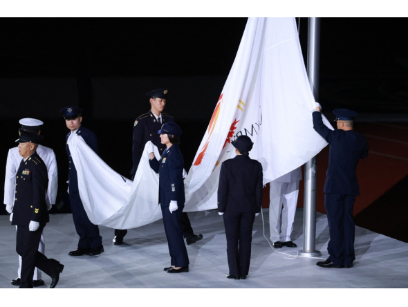 Members of the Japan Self-Defense Forces lower the Olympic Council of Asia (OCA) flag during the closing ceremony of the 2026 Asian Games at Nagoya City Mizuho Park Athletic Stadium in Nagoya, Aichi Prefecture on October 4, 2026. (Photo by David Gray / AFP)