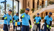 A professional cleaner providing detailed home cleaning services inside a modern residence in Qatar, highlighting the importance of adapting home care to the country’s climate and environmental conditions.