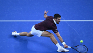 Novak Djokovic hits a return to Daniil Medvedev.