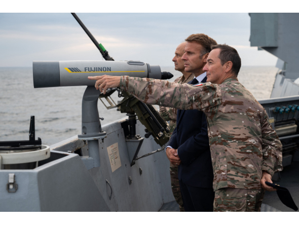This handout photograph released and taken by the French Ministry of the Armed Forces and Veterans on October 6, 2026 shows French President Emmanuel Macron (L) attending the first test launch of a new intercontinental missile, fired from a nuclear-powered ballistic missile submarine off the coast of Finistere, western France, on October 6, 2026. (Photo by Benjamin PAPIN / French Ministry of the Armed Forces and Veterans / AFP) 