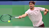 Germany's Alexander Zverev hits a return to China's Wu Yibing during their men's singles match at the Shanghai Masters tennis tournament in Shanghai on October 9, 2026. (Photo by Hector RETAMAL / AFP)