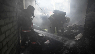 Firefighters operate to extinguish a fire inside a clinic building after a Russian aerial attack on Kharkiv on October 10, 2026. (Photo by Sergey Bobok / AFP)