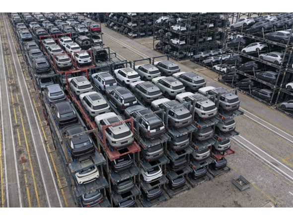 Chinese-made cars are seen in specialised vehicle racks in preparation for loading onto ships for export at the Taicang Port area of Suzhou Port on October 12, 2026. (Photo by CN-STR / AFP) 