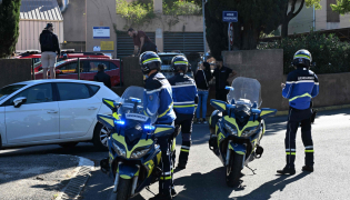 French gendarmes stand in front of Joseph-Lakanal high school after a headmaster was injured by a hunting rifle shot and a teenager was arrested in Aubagne, southern France, on October 12, 2026. (Photo by Miguel MEDINA / AFP)
