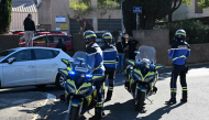 French gendarmes stand in front of Joseph-Lakanal high school after a headmaster was injured by a hunting rifle shot and a teenager was arrested in Aubagne, southern France, on October 12, 2026. (Photo by Miguel MEDINA / AFP)
