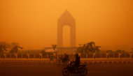 Motorcyclists ride in the morning in Palangkaraya, Central Kalimantan on October 14, 2026, amid thick haze from forest and land fires in the region. (Photo by Reina / AFP)