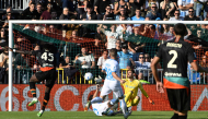Venezia FC's Nigerian forward #45 Akor Adams (L) scores a goal during the Italian Serie A football match between Venezia and Napoli at the Pier Luigi Penzo Stadium, in Venice northeastern Italy, on October 17, 2027. (Photo by ANDREA PATTARO / AFP)