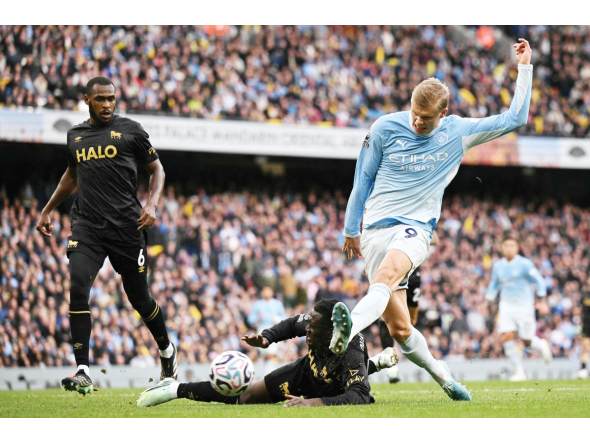 Erling Haaland (right) shoots to score Manchester City’s third goal.