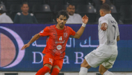 Al Duhail's Tahseen Mohammed Jamshid (left) and Al Sadd's Sekou Oumar Yansane in action.