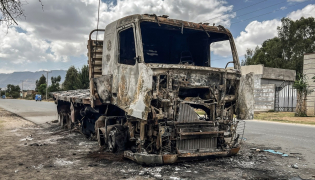 A truck belonging to the Tigray People's Liberation Front (TPLF) stands burned along a road following clashes between Ethiopian federal forces and armed groups opposed to the government in Adigrat on October 17, 2026. (AFP)
