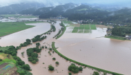 In this file photo July 25, 2024 and released courtesy of the Akita Prefecture River Sabo Division to AFP on July 26, shows flooding along the Ishizawa river, whose embankment collapsed due to heavy rains, in Yurihonjo, Akita prefecture. Photo by Handout / Akita Prefecture River Sabo Division / AFP   