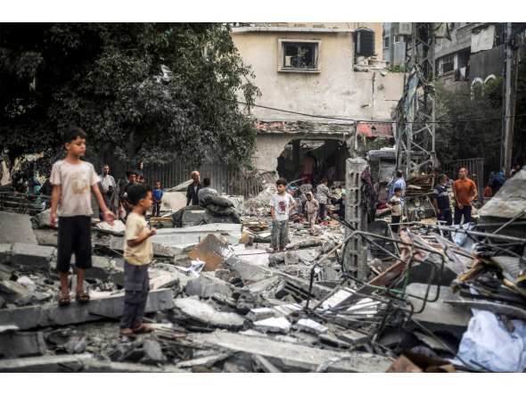 Children stand by the rubble of a destroyed building following an Israeli airstrike in Nuseirat in the central Gaza Strip on October 23, 2026. (Photo by EYAD BABA / AFP)