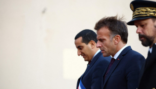French President Emmanuel Macron (C) walks with Mayor of Trappes Ali Rabeh (L) during a visit following a shooting in Trappes, near Paris on October 23, 2026. (Photo by Hannah McKay / POOL / AFP)