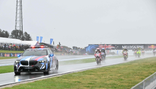 The safety car leads MotoGP riders in a farewell lap following the cancellation of the last Australian MotoGP Grand Prix to be held at Phillip Island on October 25, 2026, due to inclement weather conditions. (Photo by Paul Crock / AFP)