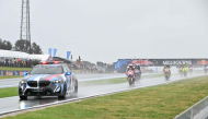 The safety car leads MotoGP riders in a farewell lap following the cancellation of the last Australian MotoGP Grand Prix to be held at Phillip Island on October 25, 2026, due to inclement weather conditions. (Photo by Paul Crock / AFP)