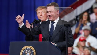 Audi AG CEO Gernot Dollner speaks alongside US President Donald Trump during a midterm campaign rally at the Guardian Centers on October 24, 2026 in Perry, Georgia. Alex Wong/Getty Images/AFP 