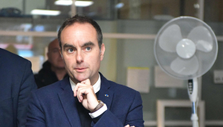 :France's Prime Minister Sebastien Lecornu (C) reacts at a police station during a visit to Limoges in the context of security and reconstruction efforts after a group of individuals forced entry into the building during last weekend's protest action against the 