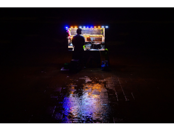 A vendor selling prawns waits for customers at the Galle Face seafront promenade, during a rainy night in Colombo on October 26, 2026. (Photo by Ishara S. KODIKARA / AFP)