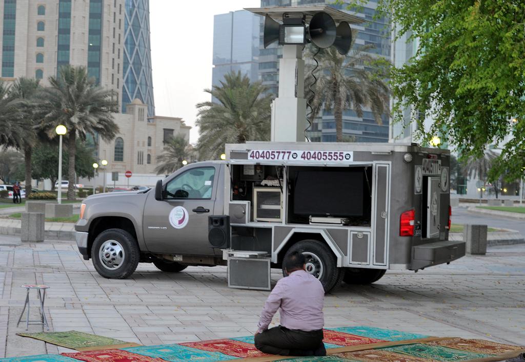 A man prays near a ‘mobile mosque’ at the Sheraton Park in Doha yesterday.  (Pic: Kammutty VP/The Peninsula)