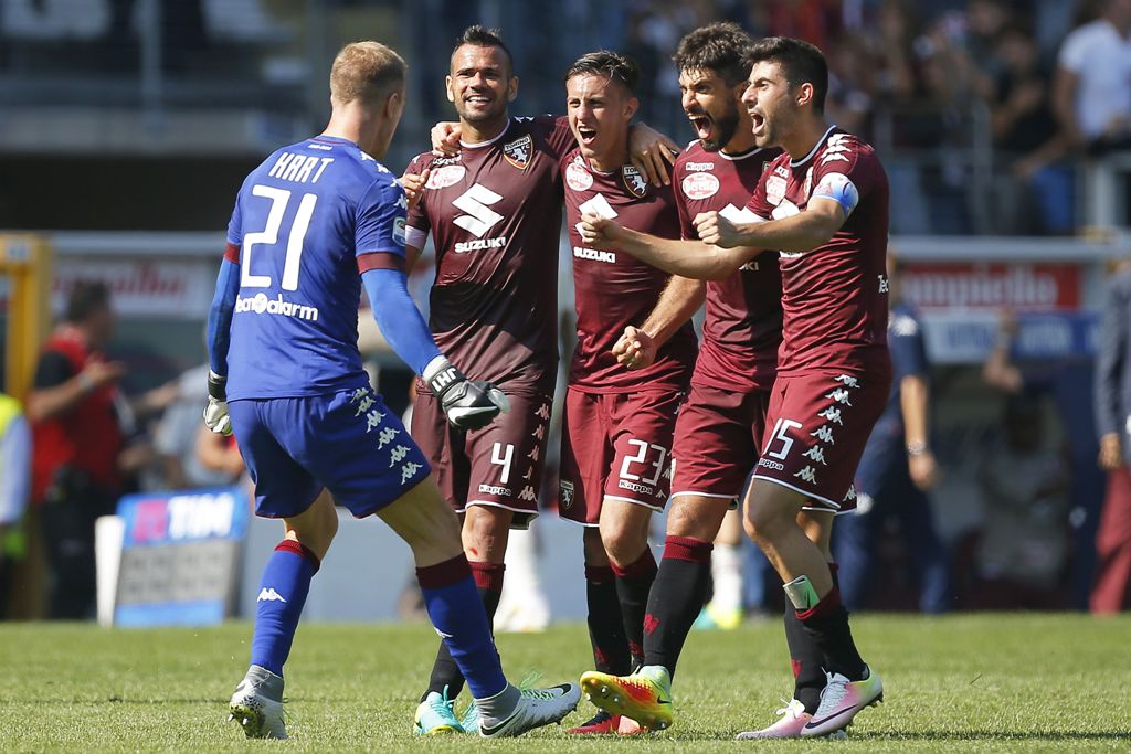 Torino's players celebrate at the end of the Italian Serie A football match between Torino and AS Roma at the 