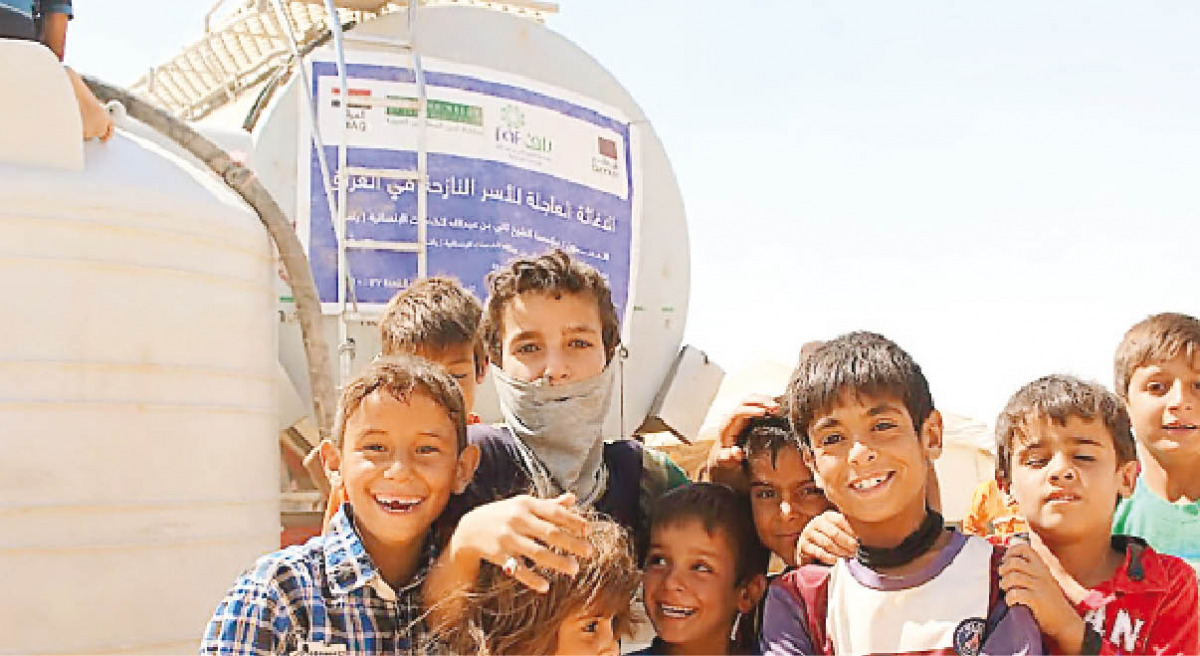 Children in front of a water tank provided by RAF in Iraq.