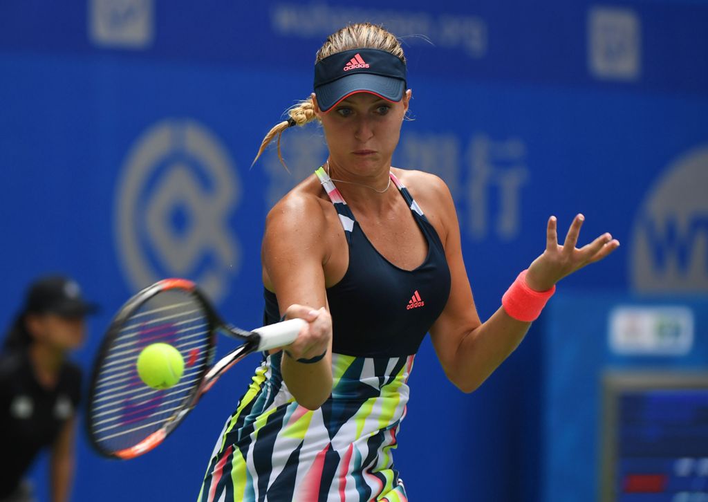 Kristina Mladenovic of France hits a return during her second round match against Angelique Kerber of Germany at the WTA Wuhan Open in Wuhan, in China's central Hubei province on September 27, 2016. / AFP / GREG BAKER
