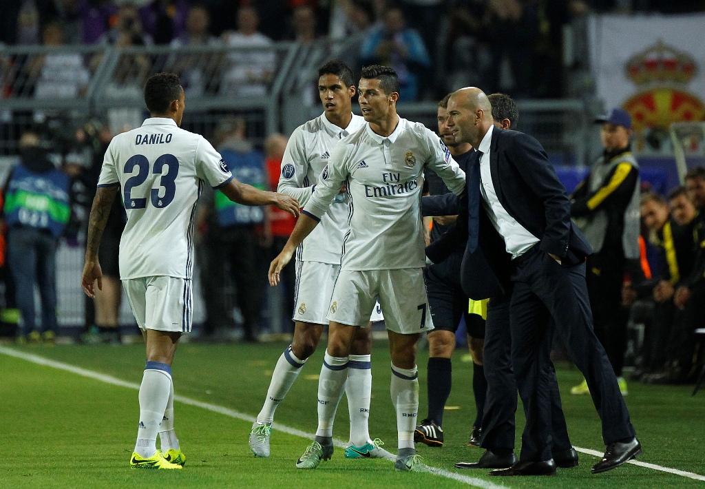 Cristiano Ronaldo(C) and Head coach Zinedine Zidane(R) of Real Madrid CF celebrate after scoring a goal during the UEFA Champions League group F soccer match between Borussia Dortmund and Real Madrid CF at the Signal Iduna Park stadium in Dortmund, German